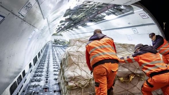 Workers loading cargo aircraft